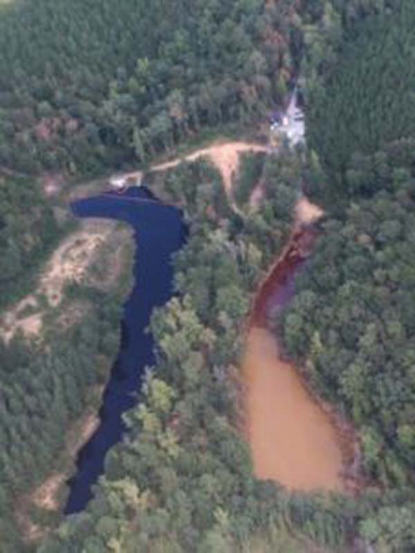 An aerial photo of a man-made mine retention basin Pond 2 (R) and Pond 3 seen in a picture taken September 19, 2016 in Shelby County, Alabama and provided by the Colonial Pipeline Company. Gasoline which spilled from a pipeline leak is contained to retention area Pond 2 and skimming operations continue. Colonial Pipeline Company/Handout via Reuters
