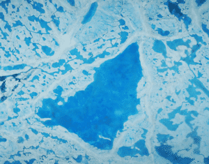A large pool of melt water over ice on top of the Beaufort Sea in the Arctic Ocean. Photograph: Operation IceBridge/Nasa 